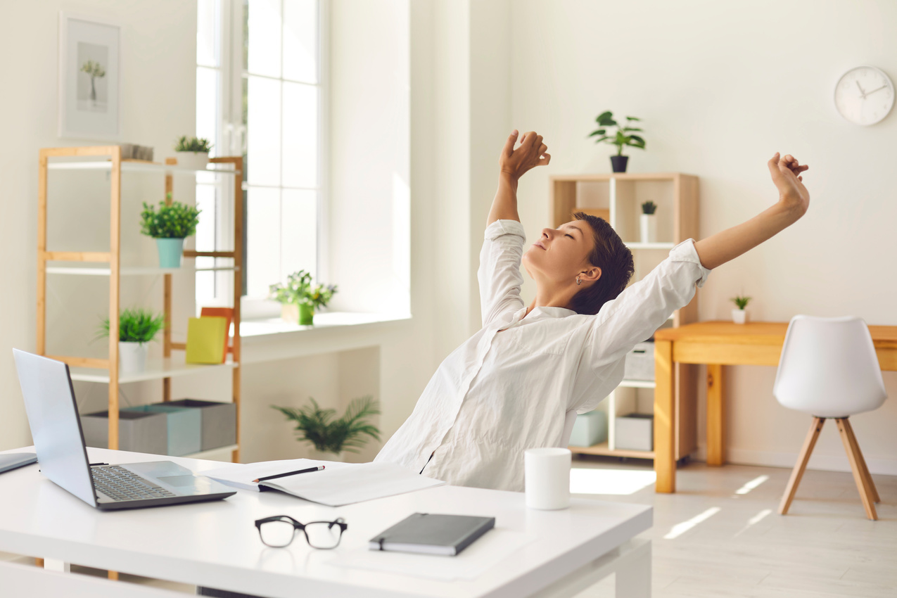 Business Woman Sitting at Office Desk, Taking Break from Work and Stretching Stiff, Tense Muscles